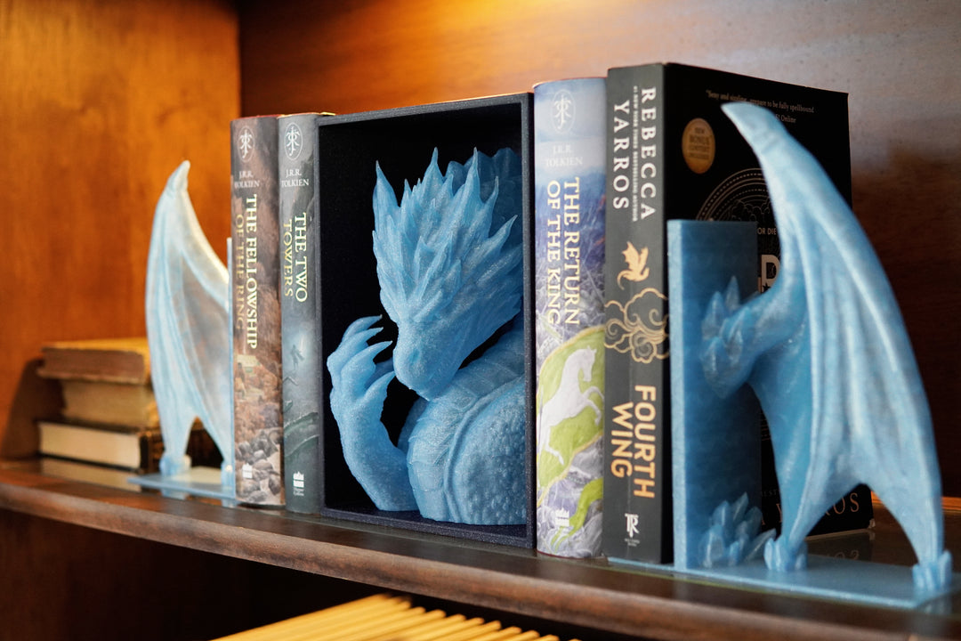Bookends shaped like dragons on a shelf with books