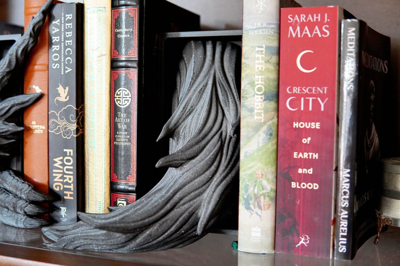 Books arranged on a shelf with decorative elements