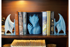 Bookends shaped like dragons on a bookshelf with books.