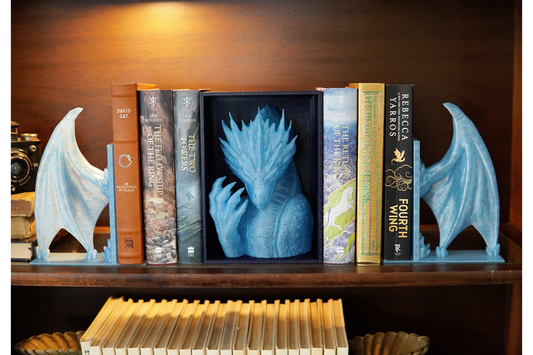 Bookends shaped like dragons on a bookshelf with books.