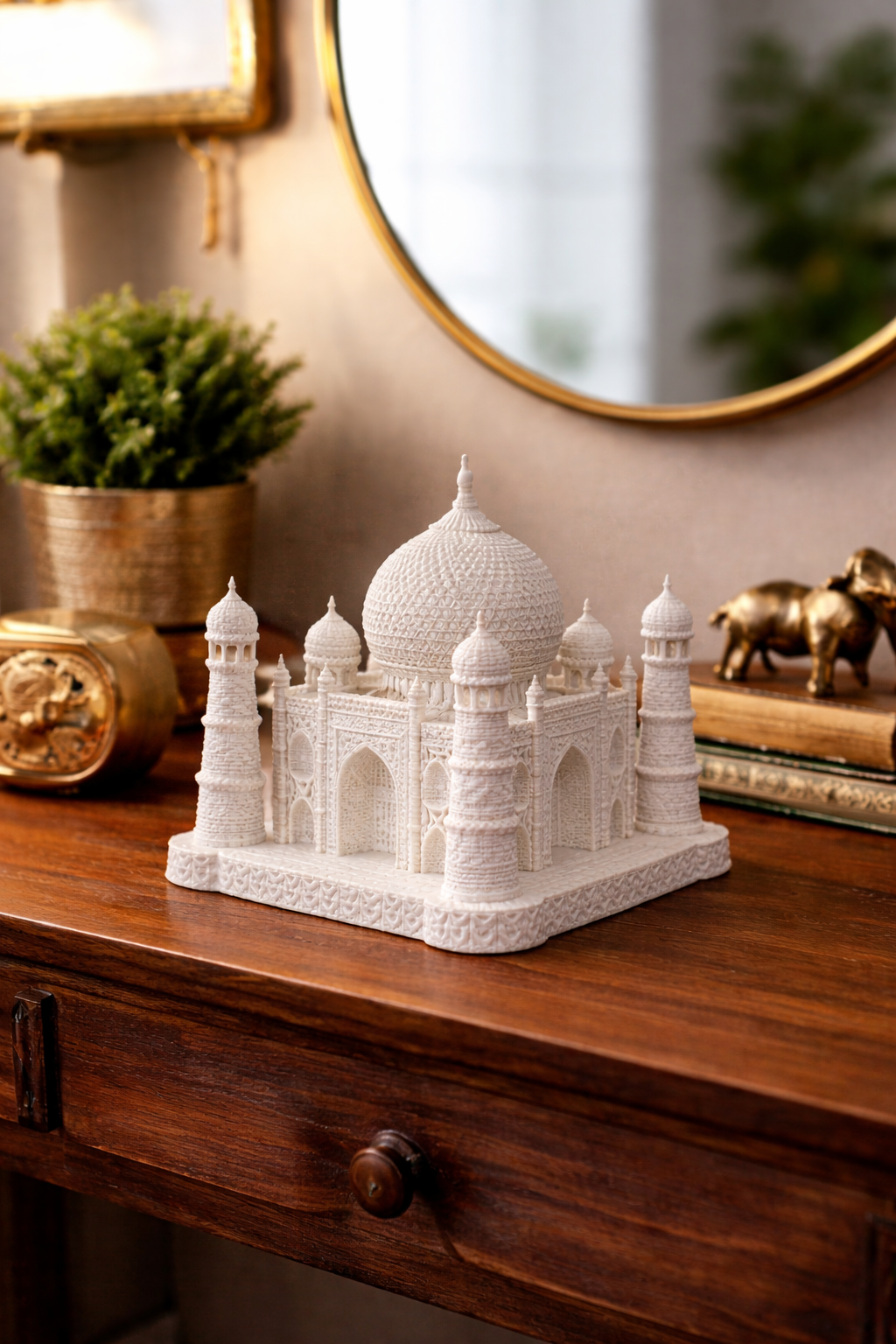 Model of the Taj Mahal on a wooden surface with decorative items in the background