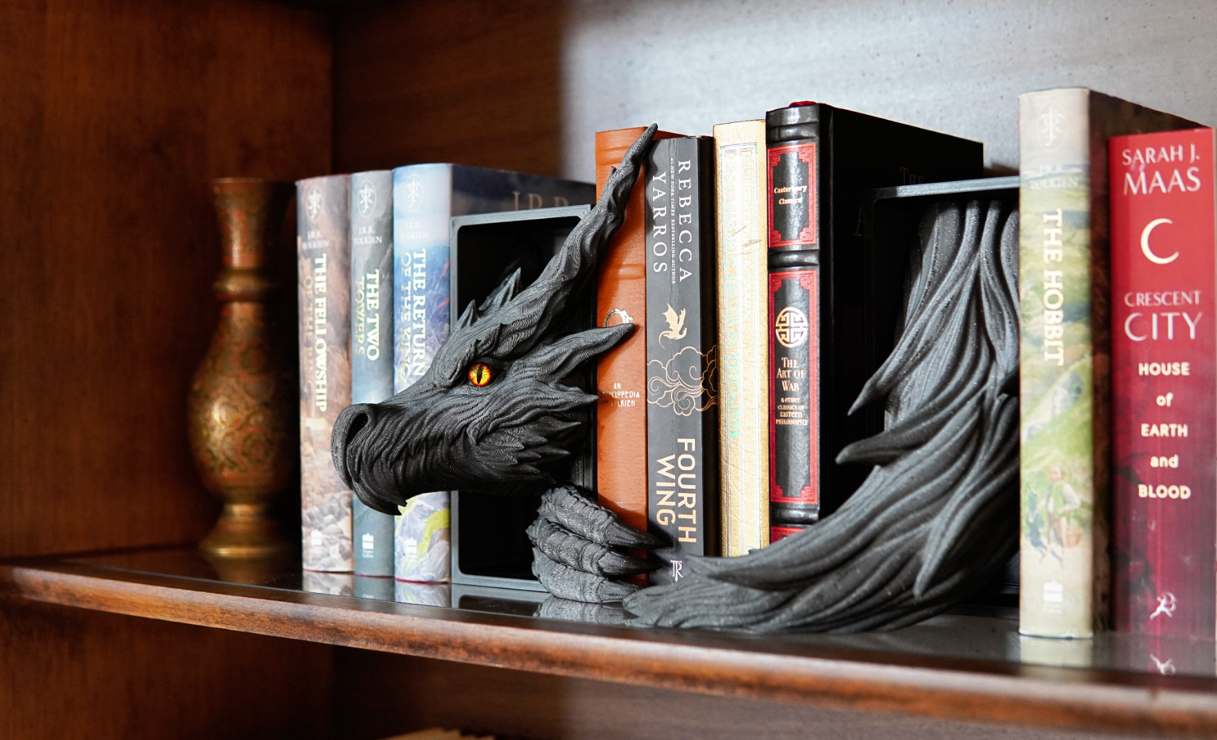Dragon bookend on a shelf with books