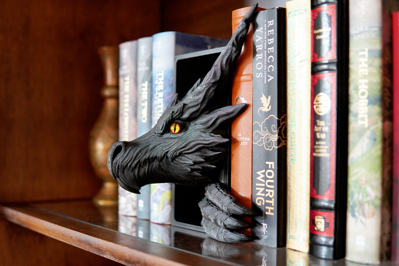 Dragon bookend on a shelf with books