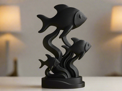 Graceful black fish trio sculpture with flowing curves and underwater elegance in matte black finish