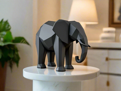 Black low poly geometric elephant sculpture on white pedestal - modern minimalist home decor for Indian homes