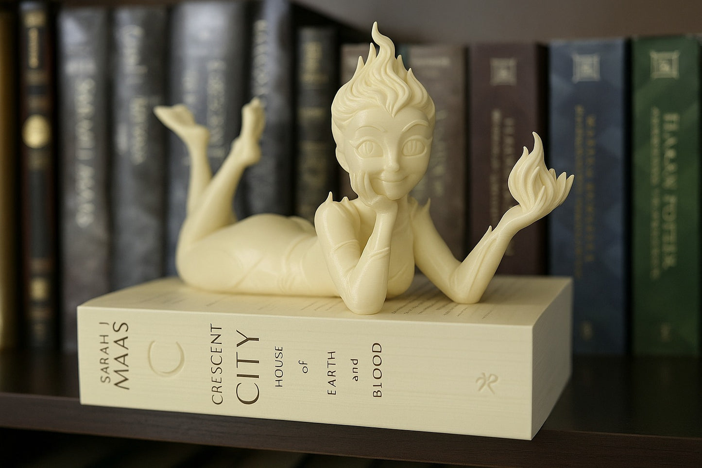 White figurine on a book with books in the background