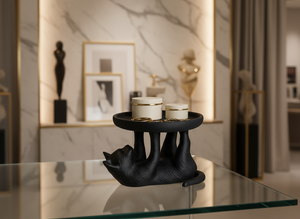 Black cat-shaped candle holder with two candles on a glass table in a stylish room.