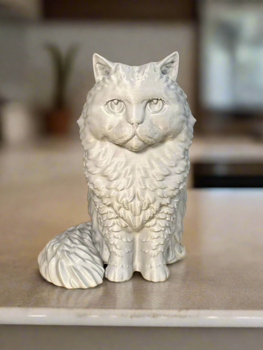 A white fluffy cat statue with a realistic appearance, made with high-quality materials, placed on a marble surface.