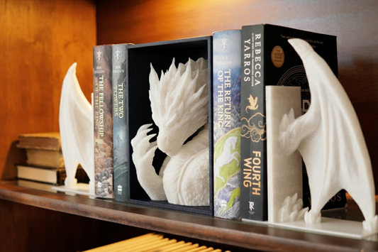 Bookends shaped like dragons on a shelf with books