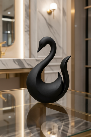 Black swan sculpture on a reflective surface with a blurred interior background